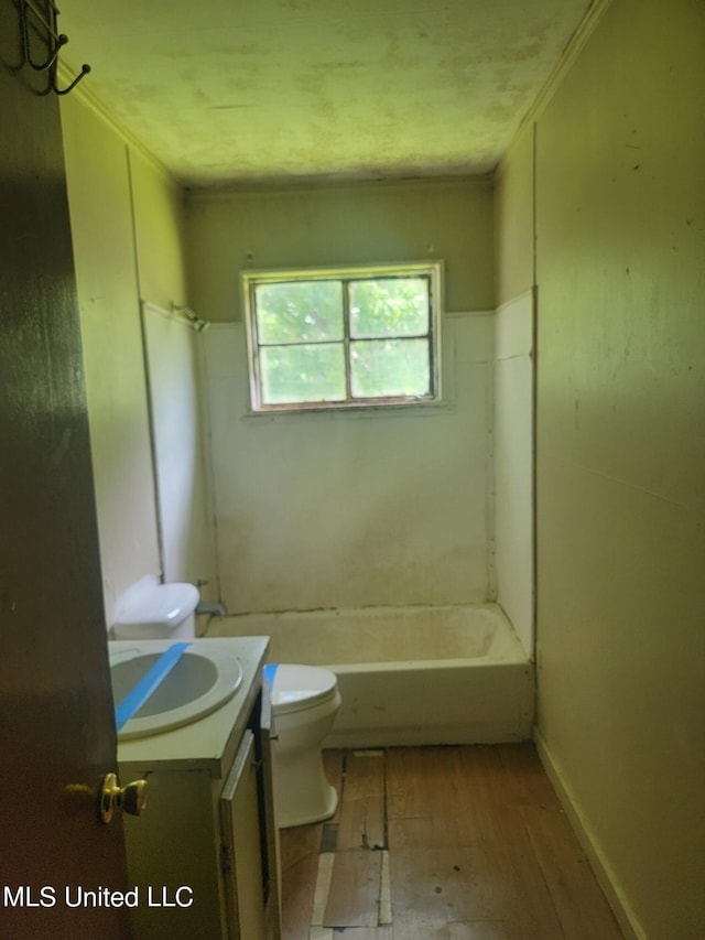 full bathroom featuring toilet, hardwood / wood-style floors, vanity, and washtub / shower combination