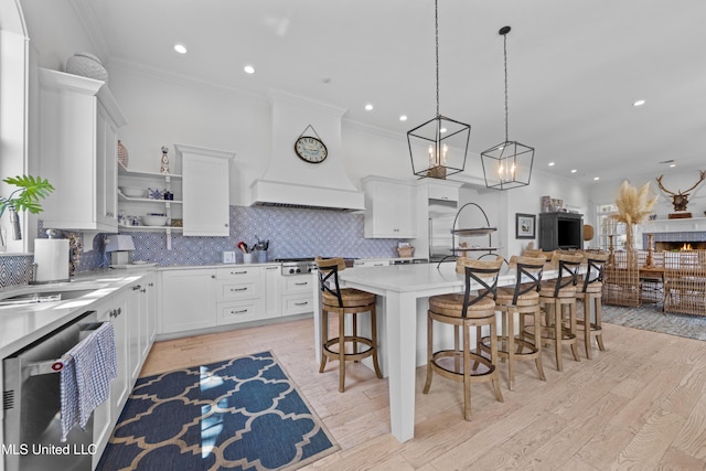 1221 E Beach Blvd, Pass Christian, MS 39571 - kitchen featuring appliances with stainless steel finishes, open shelves, a kitchen breakfast bar, light countertops, and crown molding