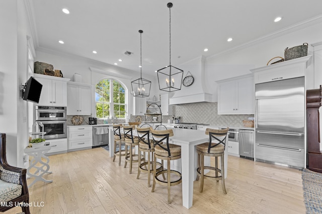 1221 E Beach Blvd, Pass Christian, MS 39571 - kitchen featuring stainless steel appliances, a kitchen bar, light countertops, a center island, and tasteful backsplash