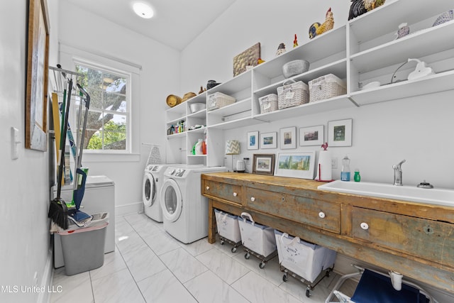1221 E Beach Blvd, Pass Christian, MS 39571 - laundry room featuring washer and dryer, light marble finish flooring, and baseboards