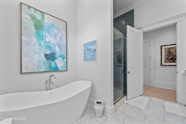 1221 E Beach Blvd, Pass Christian, MS 39571 - full bathroom featuring marble look tile flooring, a soaking tub, baseboards, a stall shower, and crown molding