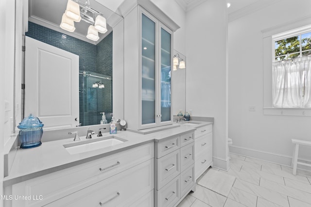 1221 E Beach Blvd, Pass Christian, MS 39571 - bathroom featuring double vanity, a shower stall, crown molding, toilet, and marble finish floors