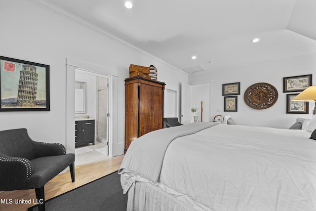 1221 E Beach Blvd, Pass Christian, MS 39571 - bedroom with ornamental molding, recessed lighting, ensuite bathroom, and light wood-style flooring