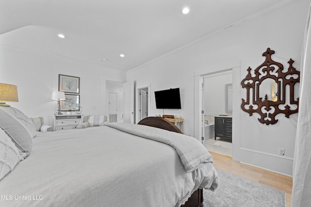 1221 E Beach Blvd, Pass Christian, MS 39571 - bedroom featuring crown molding, recessed lighting, connected bathroom, and light wood-style floors