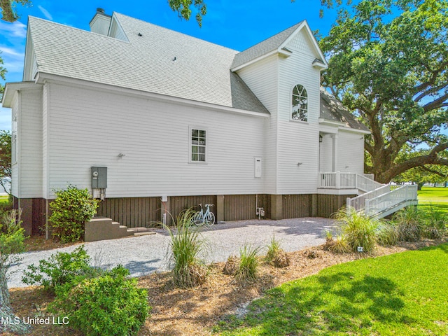 1221 E Beach Blvd, Pass Christian, MS 39571 - rear view of house featuring roof with shingles, a chimney, and a deck