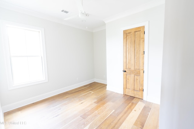 empty room with ornamental molding, light hardwood / wood-style flooring, and ceiling fan