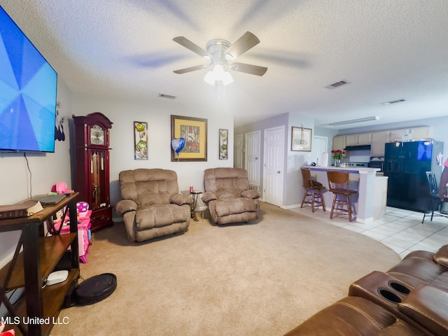 5080 Gautier Vancleave Rd Unit D-8, Gautier, MS 39553 - living area featuring ceiling fan, light carpet, a textured ceiling, and light tile patterned flooring