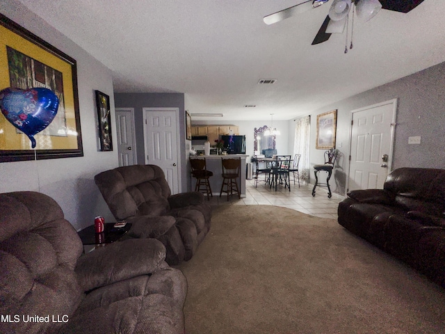 5080 Gautier Vancleave Rd Unit D-8, Gautier, MS 39553 - living area featuring a ceiling fan, light tile patterned floors, and light colored carpet