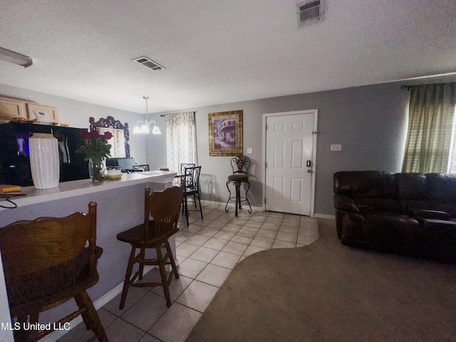 5080 Gautier Vancleave Rd Unit D-8, Gautier, MS 39553 - living area with light tile patterned floors, a textured ceiling, a chandelier, and baseboards