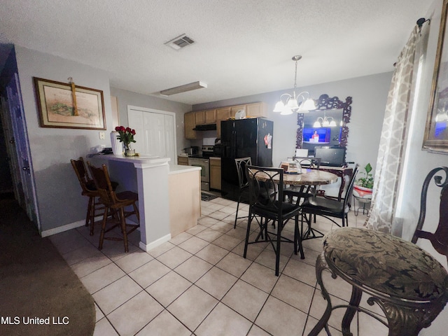 5080 Gautier Vancleave Rd Unit D-8, Gautier, MS 39553 - dining area with light tile patterned flooring, a chandelier, and a textured ceiling