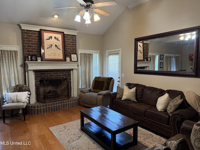 2043 Branch Creek Dr, Byram, MS 39272 - living room featuring a ceiling fan, wood finished floors, vaulted ceiling, and a brick fireplace