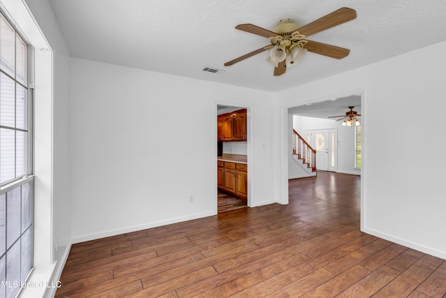 16609 Old River Rd, Vancleave, MS 39565 - unfurnished room with a ceiling fan, healthy amount of natural light, hardwood / wood-style flooring, and stairs