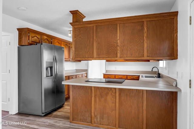 16609 Old River Rd, Vancleave, MS 39565 - kitchen featuring stainless steel fridge with ice dispenser, black electric cooktop, a sink, a peninsula, and light wood-style flooring