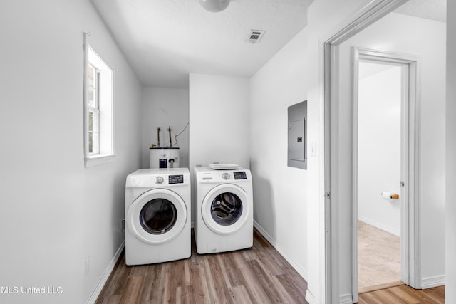 16609 Old River Rd, Vancleave, MS 39565 - washroom featuring electric panel, electric water heater, separate washer and dryer, wood finished floors, and baseboards