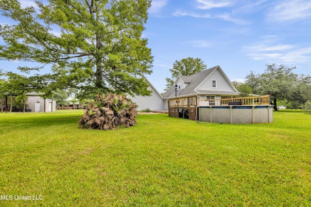 16609 Old River Rd, Vancleave, MS 39565 - view of green lawn featuring an outdoor pool and a wooden deck
