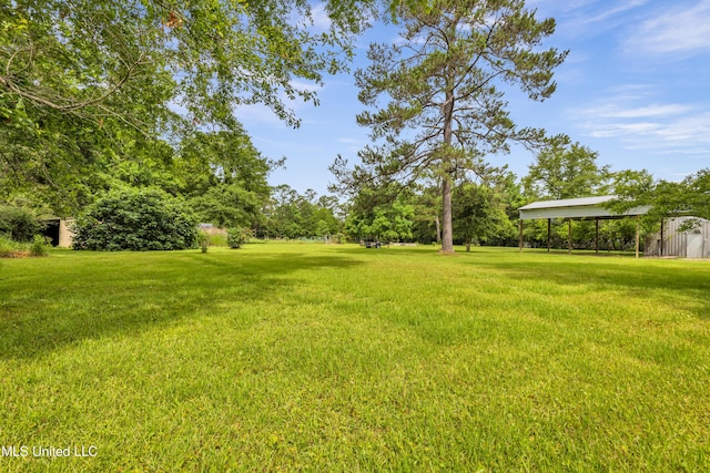 16609 Old River Rd, Vancleave, MS 39565 - view of green lawn featuring a detached carport and an outbuilding