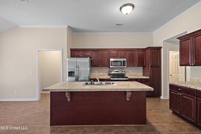 217 Belle Chasse Cir, Jackson, MS 39272 - kitchen featuring appliances with stainless steel finishes, a sink, light countertops, a breakfast bar, and crown molding