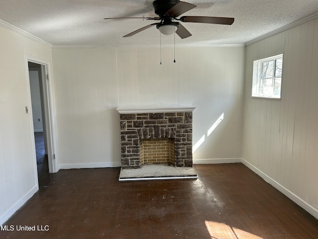 unfurnished living room with ornamental molding, a textured ceiling, wood finished floors, a stone fireplace, and baseboards