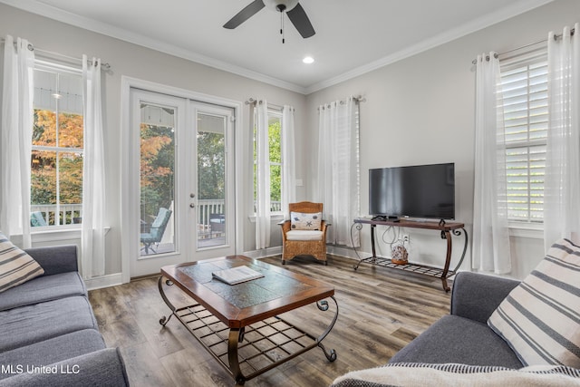 living room featuring hardwood / wood-style floors, ceiling fan, and ornamental molding