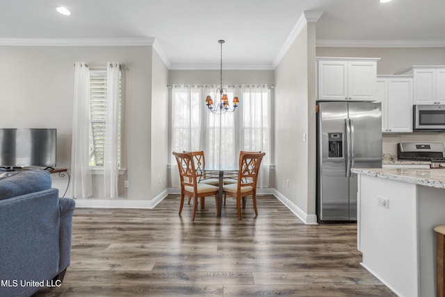 kitchen featuring white cabinets, crown molding, a notable chandelier, dark hardwood / wood-style flooring, and stainless steel appliances