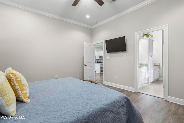 bedroom featuring hardwood / wood-style flooring, ceiling fan, crown molding, and ensuite bathroom