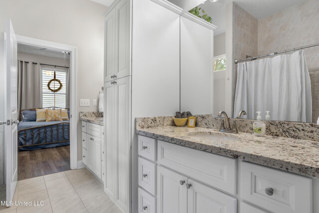 bathroom featuring tile patterned flooring and vanity