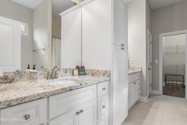 bathroom featuring tile patterned flooring and vanity