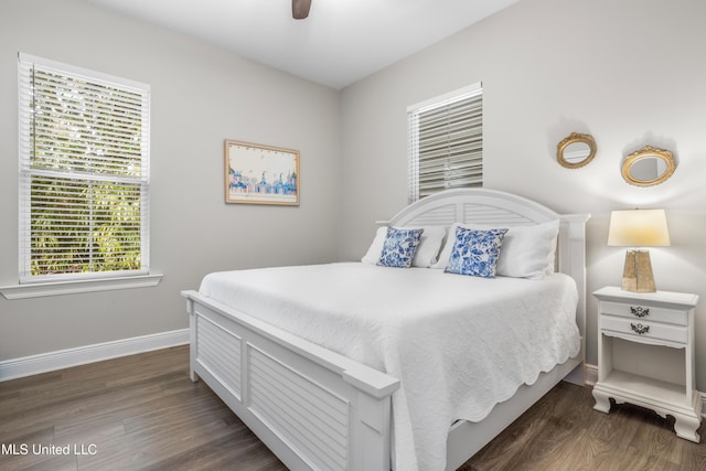 bedroom with ceiling fan and dark hardwood / wood-style flooring