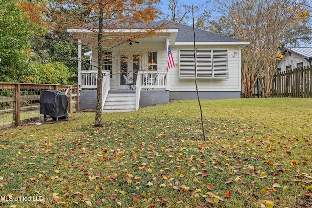 bungalow featuring a front lawn and a porch