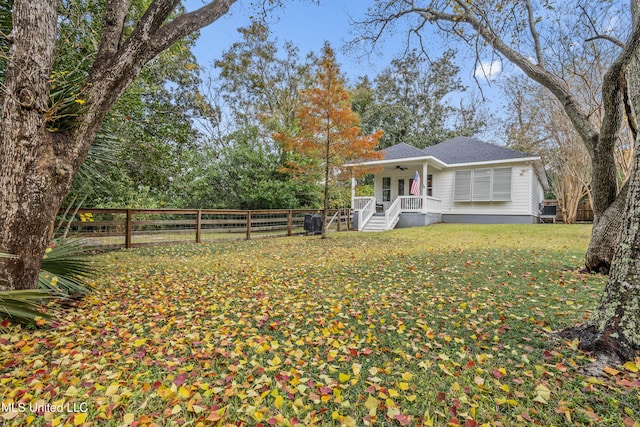 exterior space featuring a porch, ceiling fan, and a front lawn