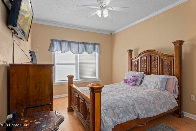 bedroom featuring ceiling fan, crown molding, a textured ceiling, and light wood-type flooring