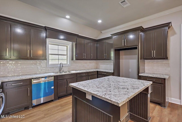 kitchen featuring light hardwood / wood-style flooring, a center island, stainless steel dishwasher, and sink