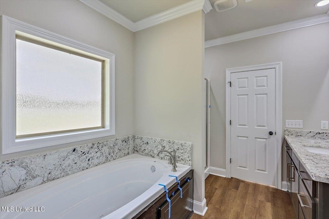 bathroom with vanity, a bathtub, ornamental molding, and hardwood / wood-style flooring