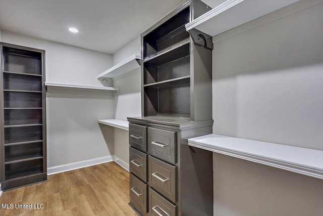 walk in closet featuring light hardwood / wood-style flooring