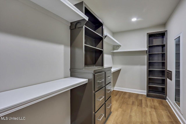 walk in closet featuring light hardwood / wood-style floors