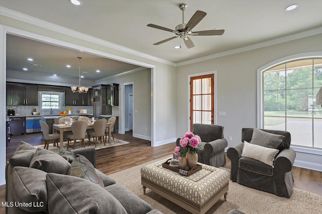 living room with crown molding, dark hardwood / wood-style floors, and ceiling fan