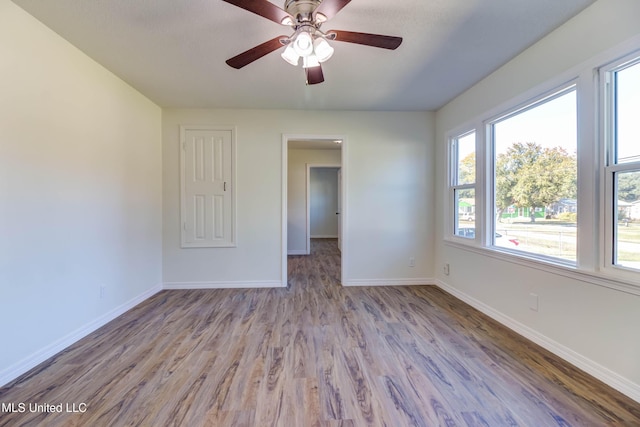 empty room with light hardwood / wood-style flooring