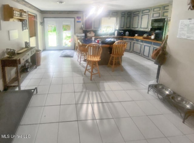 305 Bazinsky Rd, Vicksburg, MS 39180 - kitchen with light tile patterned floors, dark countertops, and french doors