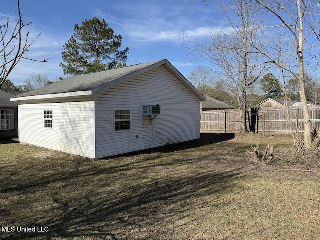 exterior space with fence and a wall mounted AC