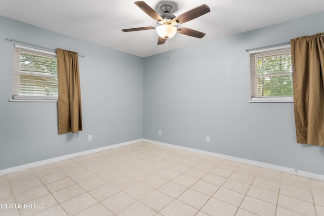 tiled empty room featuring a wealth of natural light and ceiling fan