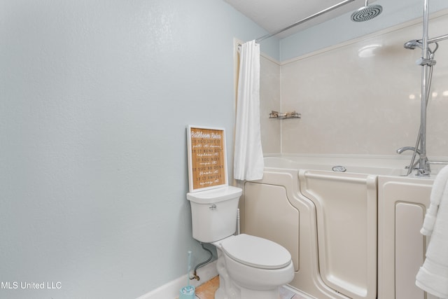 bathroom featuring tile patterned flooring and toilet