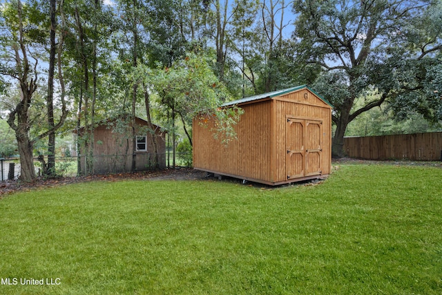 view of outdoor structure featuring a lawn