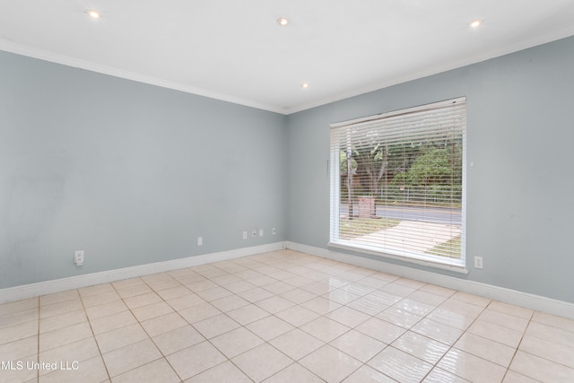 spare room with light tile patterned floors and crown molding