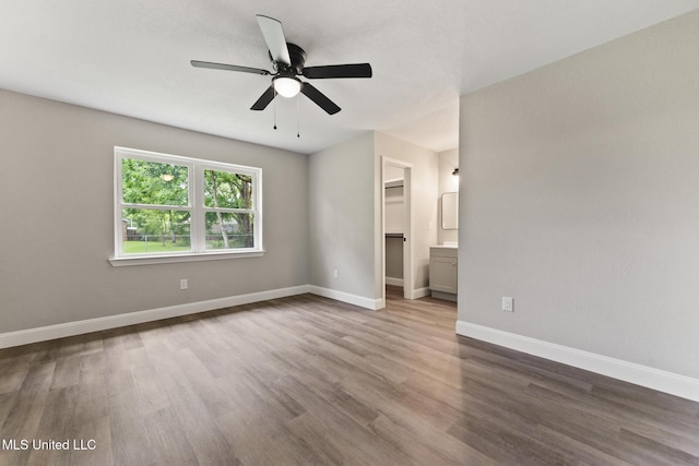 2518 El Viernes St, Gautier, MS 39553 - unfurnished bedroom with wood finished floors, a spacious closet, ceiling fan, and a closet
