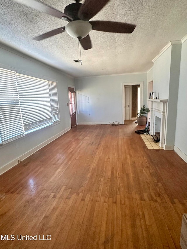 unfurnished living room featuring a textured ceiling, light hardwood / wood-style flooring, and a tile fireplace