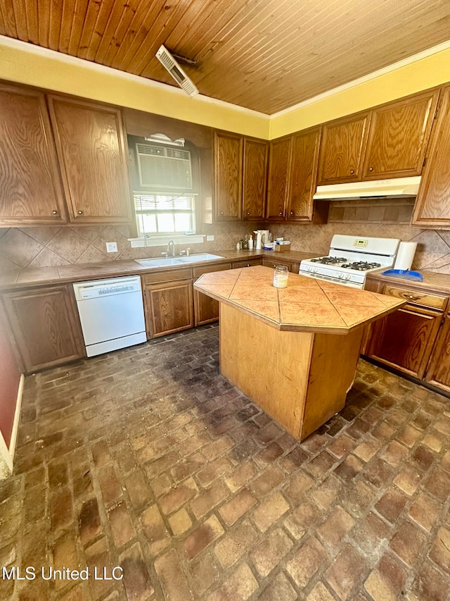 kitchen with white appliances, sink, wood ceiling, a center island, and decorative backsplash