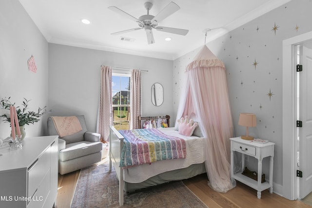 bedroom featuring ceiling fan, ornamental molding, and light hardwood / wood-style flooring