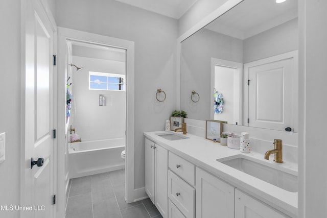 full bathroom with tile patterned flooring, tiled shower / bath, vanity, and toilet