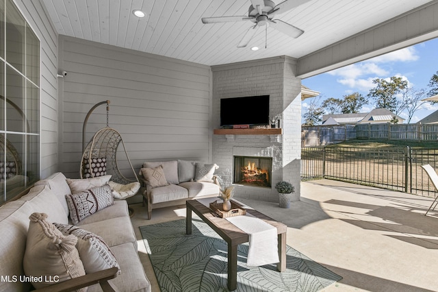 view of patio / terrace featuring ceiling fan and an outdoor living space with a fireplace