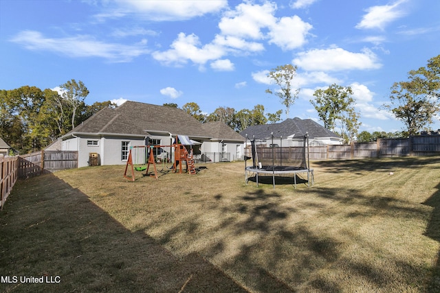 back of house with a playground, a trampoline, and a lawn